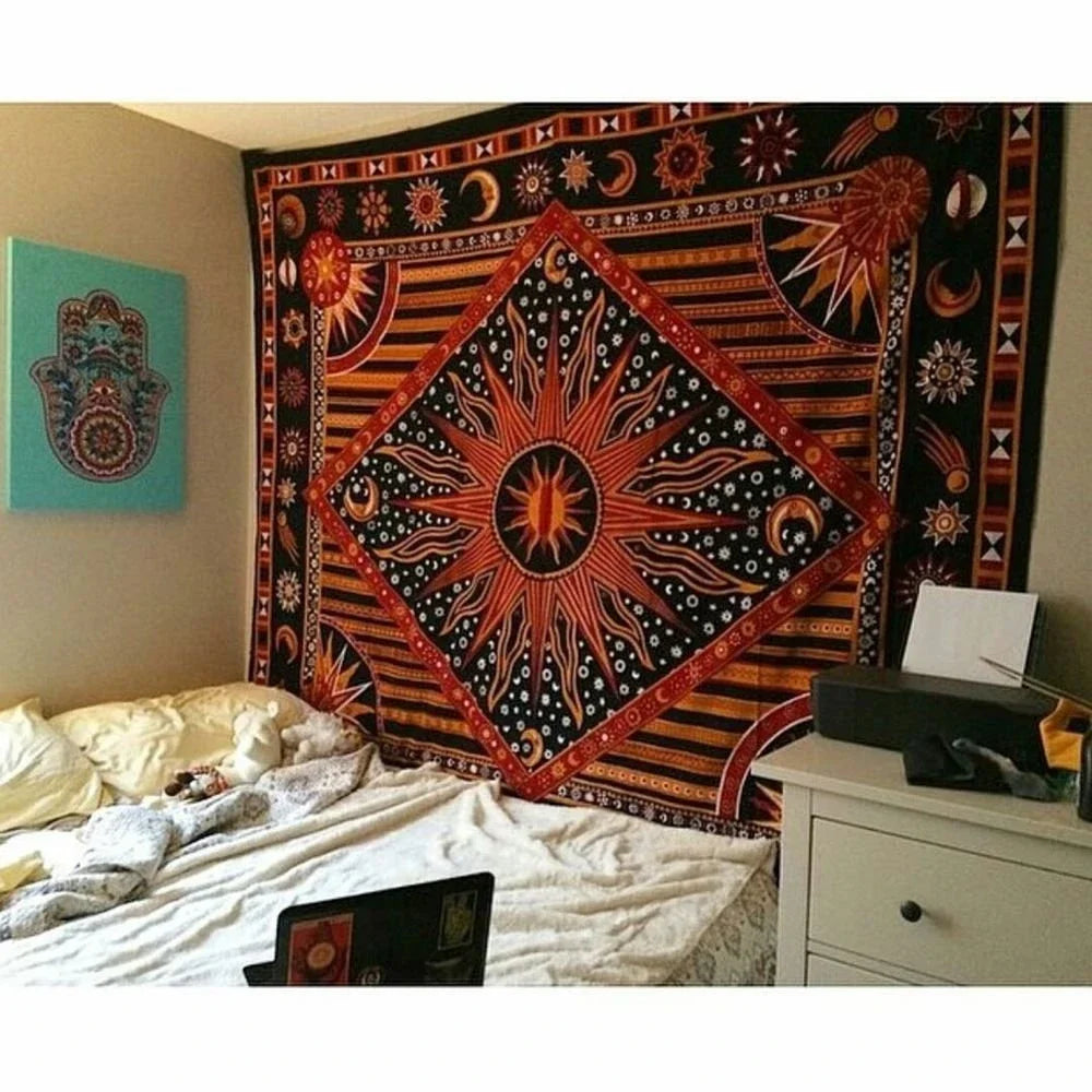 A large bohemian mandala tapestry wall hanging featuring intricate geometric patterns in black, orange, and gold on a dark ba