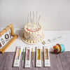 A set of six metallic twisted coil birthday candles displayed next to a decorated cake.