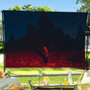 A tapestry featuring dark silhouettes of mountains and a red landscape against a night sky.