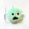 A light green plush doll with black facial features and white tufts, shown against a white background.