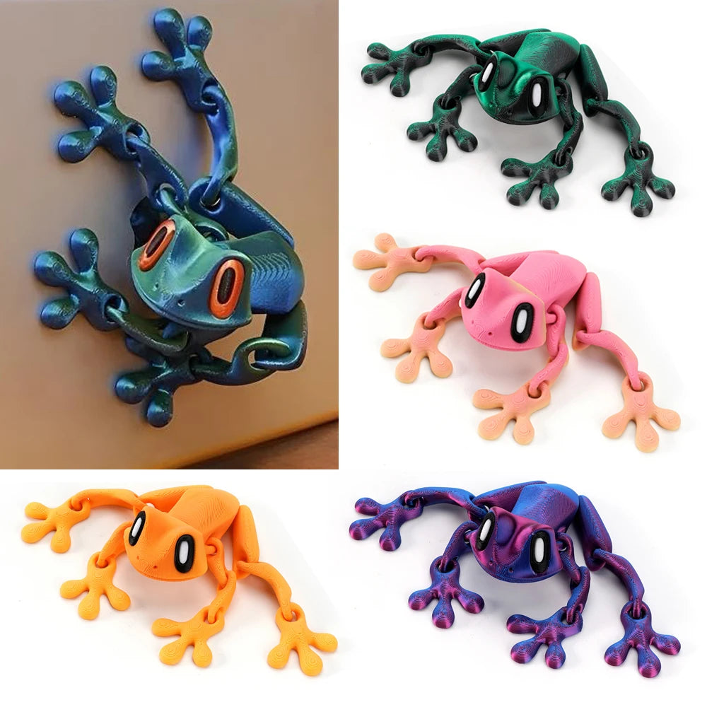 A collection of four articulated 3D printed frog magnets in various colors including blue, green, pink, and orange.