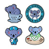 A set of enamel pins featuring cartoon koala tea, a certified koala-ty-pun, and a koala with a flower design.