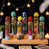A display of natural crystal zodiac wishing bottles filled with various colored healing stones on a wooden tray.