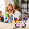 A mother and child smiling while holding a butterfly acrylic keepsake plaque for mom