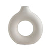 A smooth, off-white ceramic circular vase with a rounded, organic shape.