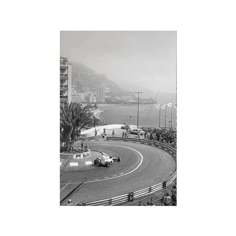 Black and white photo of a vintage Formula Grand Prix racing event on a racetrack with hills in the background.