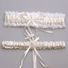 Ivory lace bowknot bridal garter set featuring delicate white lace and satin ribbons