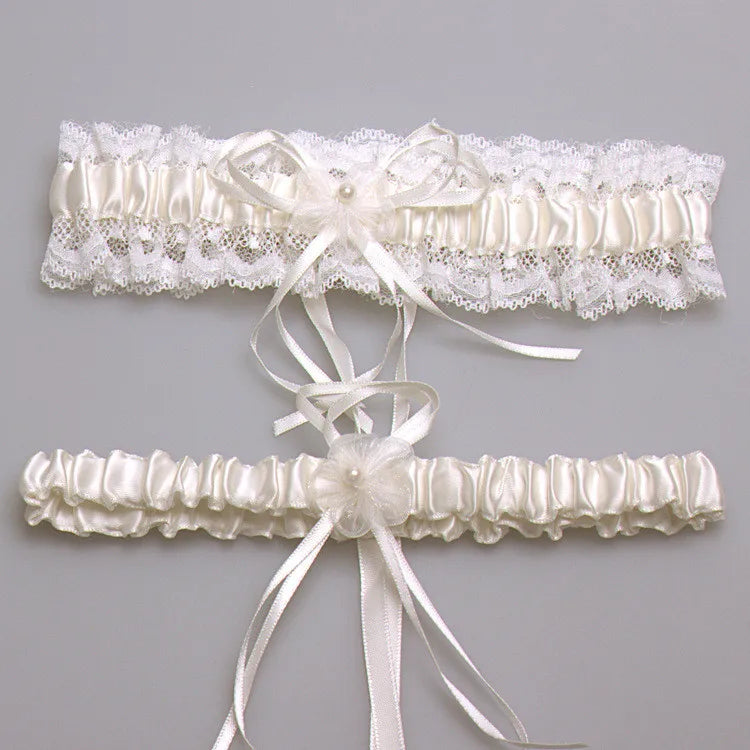 Ivory lace bowknot bridal garter set featuring delicate white lace and satin ribbons