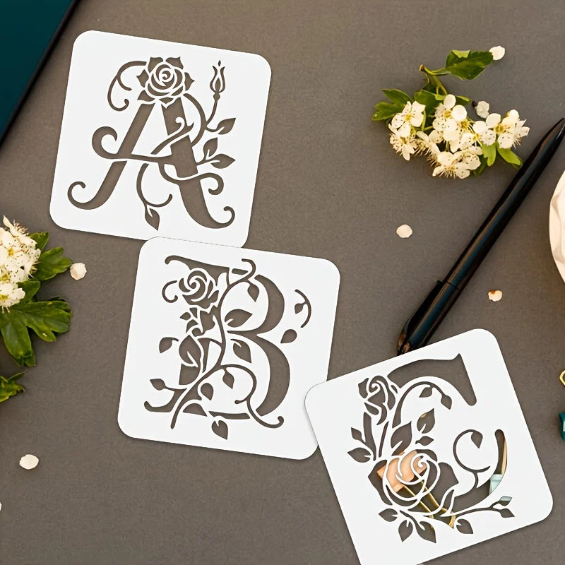 Three reusable floral alphabet stencils A, B, and C are displayed on a gray surface with greenery.