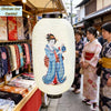 A white Japanese paper hanging lantern featuring a blue and white illustration of a woman in traditional attire.
