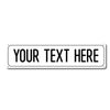 A blank white rectangular metal street sign with the text YOUR TEXT HERE printed in black.