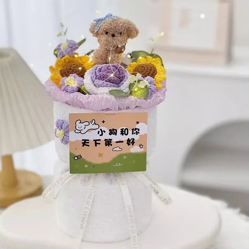 A handmade crochet flower bouquet featuring purple and yellow flowers arranged on a white stand.