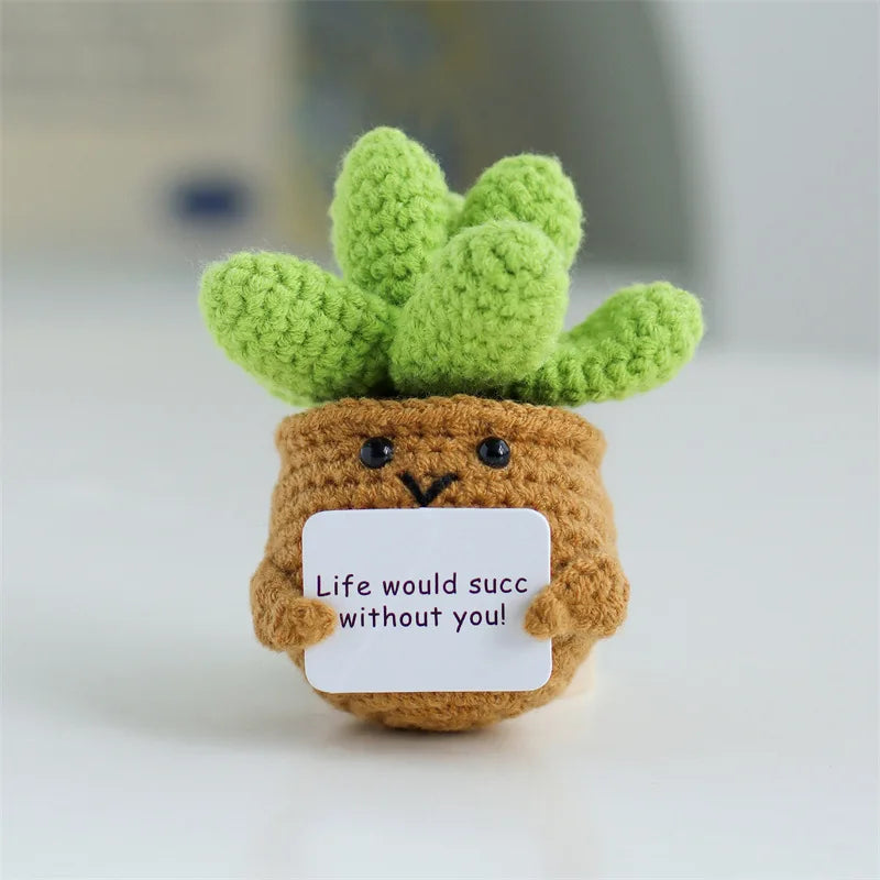 Handmade crochet sunflower desk companion with a smiling face made of green and brown yarn.