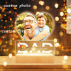 A personalized acrylic photo frame featuring a father and son, with custom text engraved on the base.