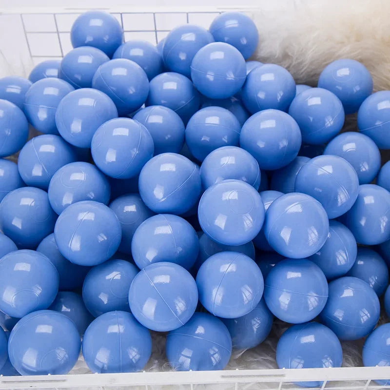 A large quantity of light blue and purple spherical balls for kids' play areas