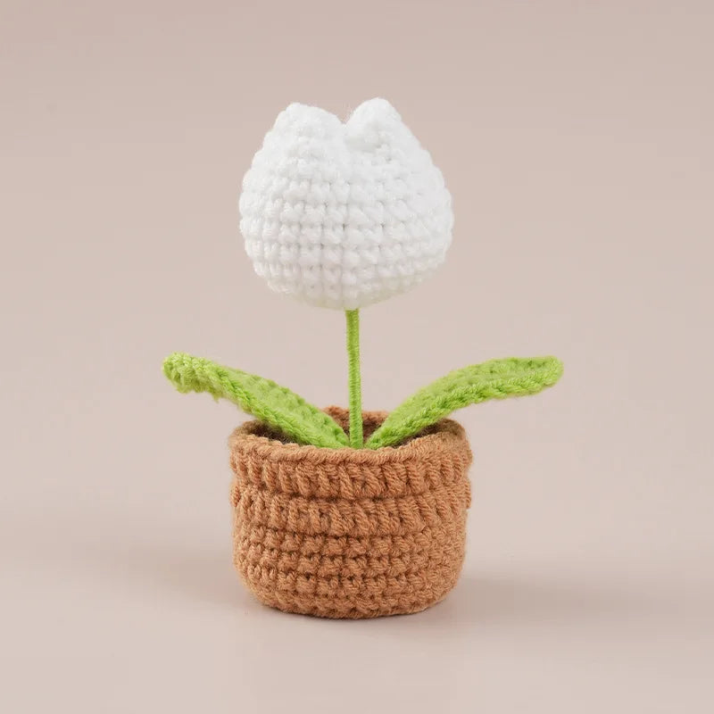 Handcrafted white crochet tulip flower growing in a brown pot