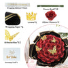A dark floral arrangement of red roses with gold glitter butterflies presented in a black decorative box.