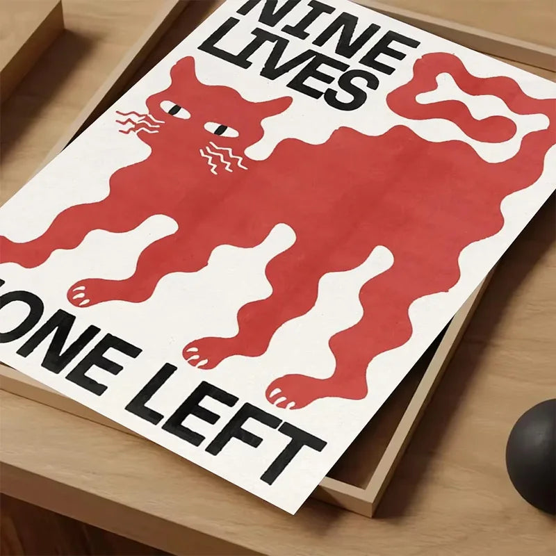A canvas print featuring a red silhouette of a cat with text that reads Nine Lives and One Left.