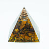 Amethyst crystal energy pyramid with a coil at the apex, set in a clear glass structure.