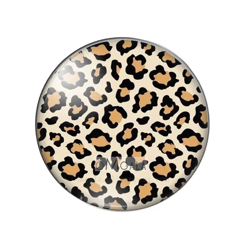 Round glass cabochons with a leopard print pattern in shades of brown and beige.