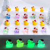 A collection of glow-in-the-dark duck figurines wearing Santa hats arranged in a row.