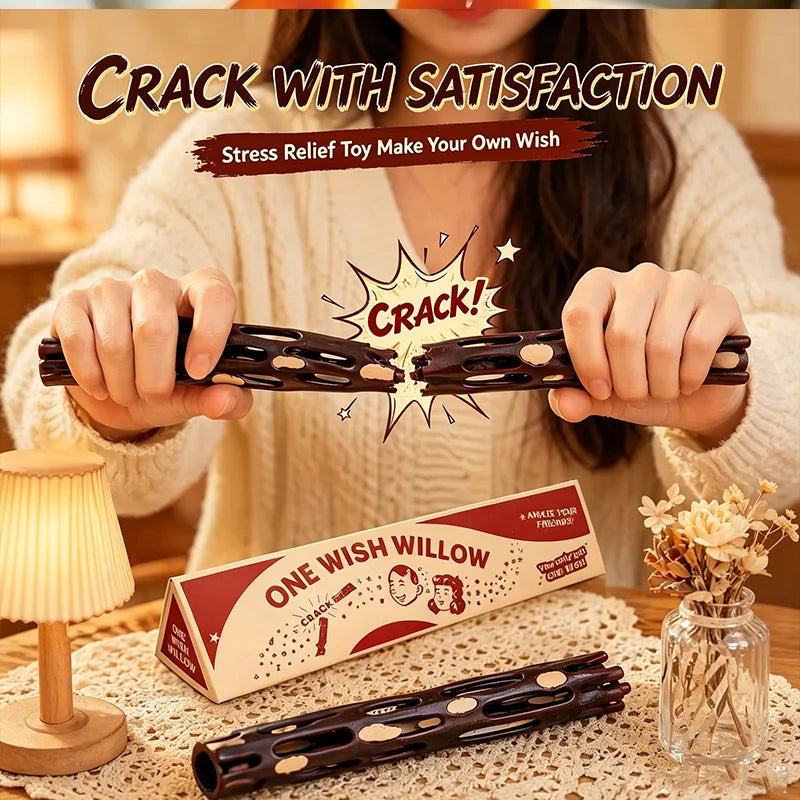 A person holds a dark wooden stick with a breakable box, demonstrating a stress relief toy for making a wish.