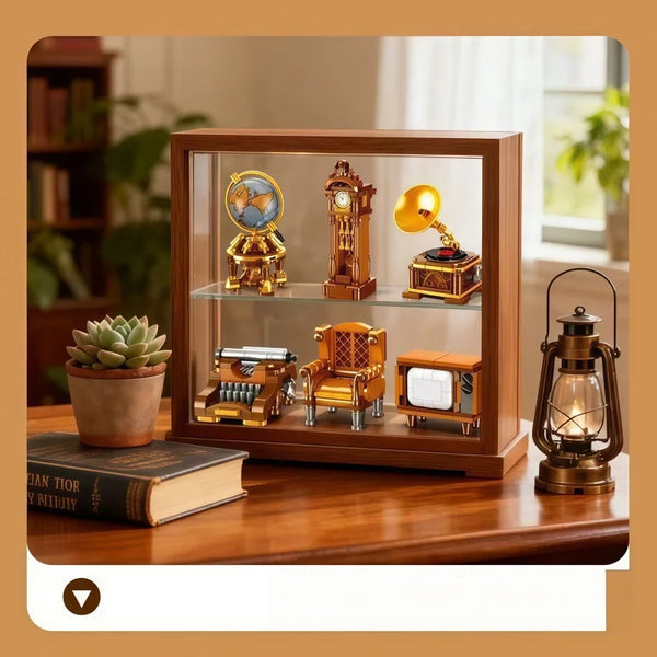 A wooden display case showcasing vintage miniature furniture and appliance models.