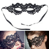 Black lace masquerade mask with black elastic straps shown on a model's face.