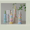 A display of handcrafted soy wax aromatherapy candles in pastel shades of pink, blue, and yellow, set against a light backgro