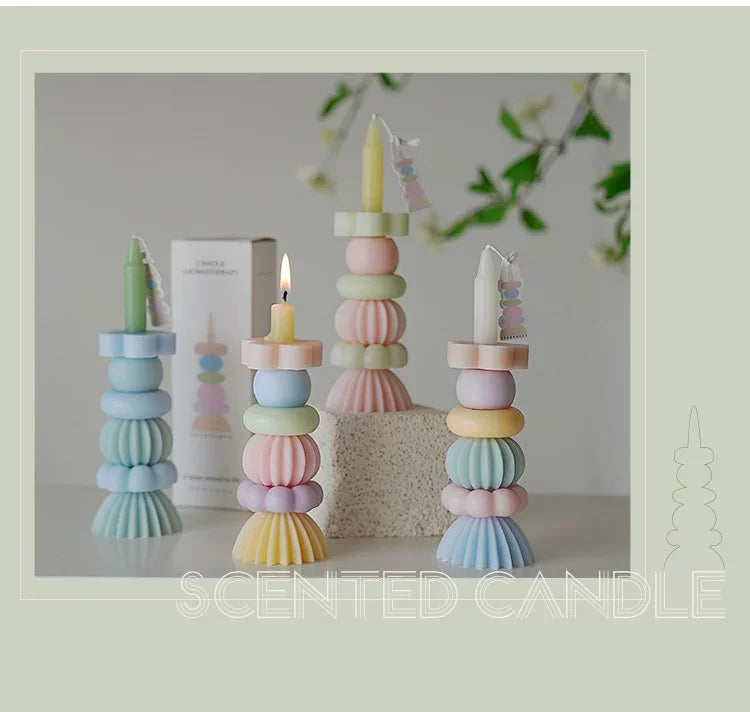 A display of handcrafted soy wax aromatherapy candles in pastel shades of pink, blue, and yellow, set against a light backgro
