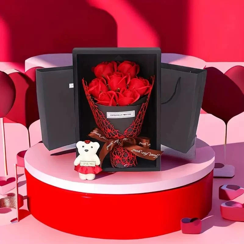 A red gift box containing a rose bouquet and a plush white bear sits on a round red pedestal.