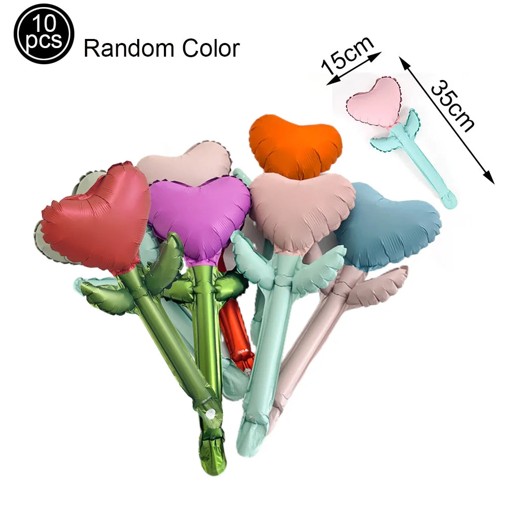 Ten random color heart letter balloons with foil finish shown next to a measuring tape.