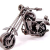 A handcrafted metal motorcycle model with chrome detailing and black finish.