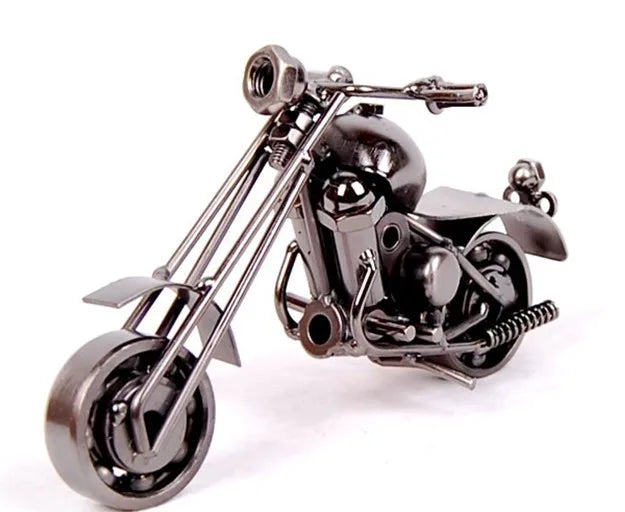 A handcrafted metal motorcycle model with chrome detailing and black finish.