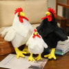 A white plush rooster and a black plush rooster sitting on a wooden surface.