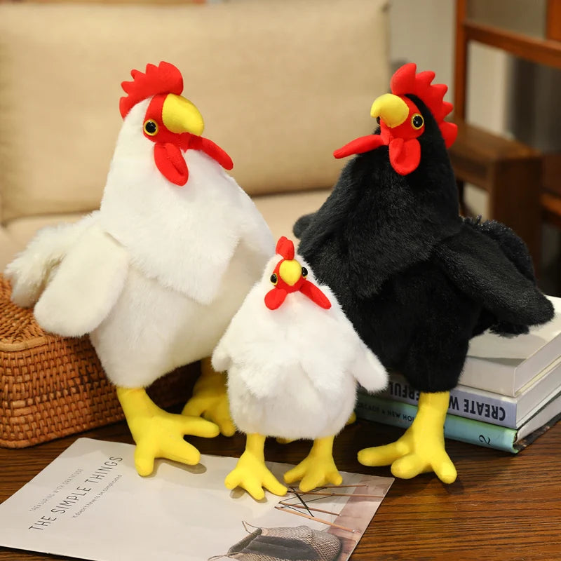 A white plush rooster and a black plush rooster sitting on a wooden surface.