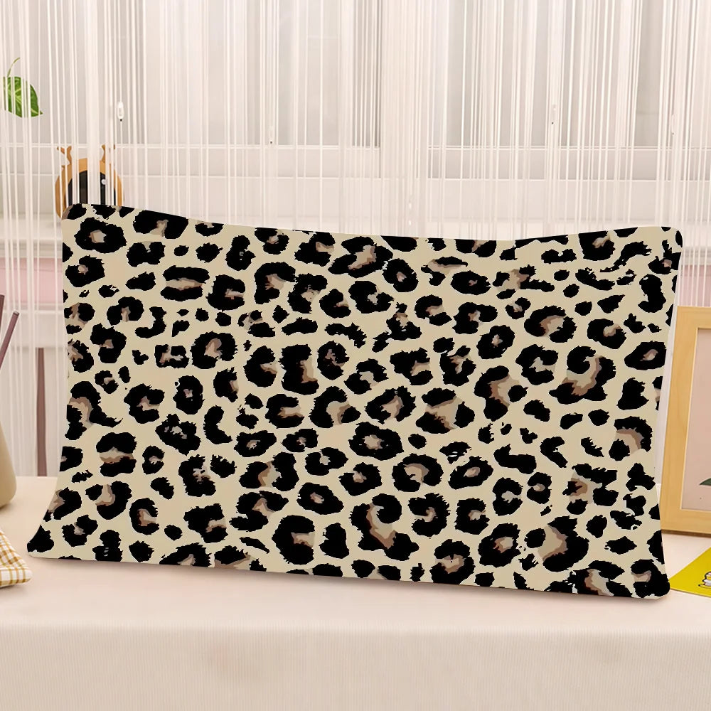 A decorative pillow cover featuring a black and tan leopard print on a white background.