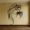 Black silhouette wall art depicting a woman with flowing hair kissing a heart-shaped object.