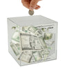 A hand is dropping a coin into a clear acrylic savings box labeled 365day savings plan.