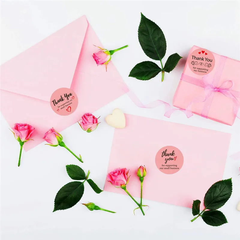 Pink envelope and gift box with thank you stickers for crafting and packaging