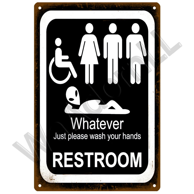A vintage metal sign with a black background and white text instructing people to wash their hands in the restroom.