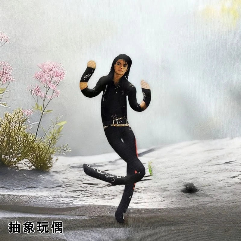 A collectible plush doll of Michael Jackson in a black outfit posing on a snowy surface.