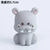 A gray, stylized elephant figurine with large ears and a trunk is shown against a white background.