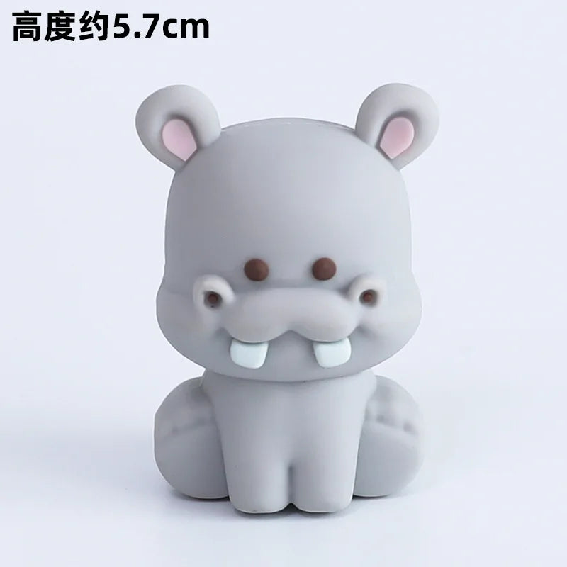A gray, stylized elephant figurine with large ears and a trunk is shown against a white background.
