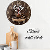 A round wooden wall clock with a coffee theme featuring a steaming cup and coffee beans.