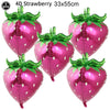 Five glossy pink strawberry shaped balloons measuring 33x55 cm for party decorations