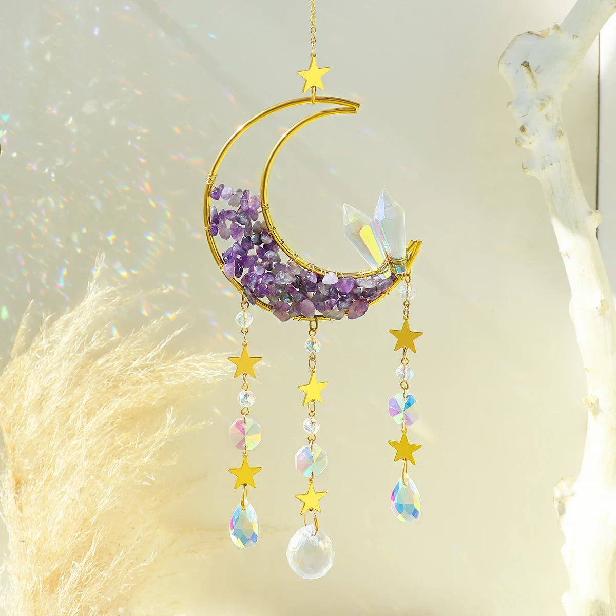 A handcrafted gold moon crystal suncatcher featuring a purple amethyst crescent and dangling prism pendants.