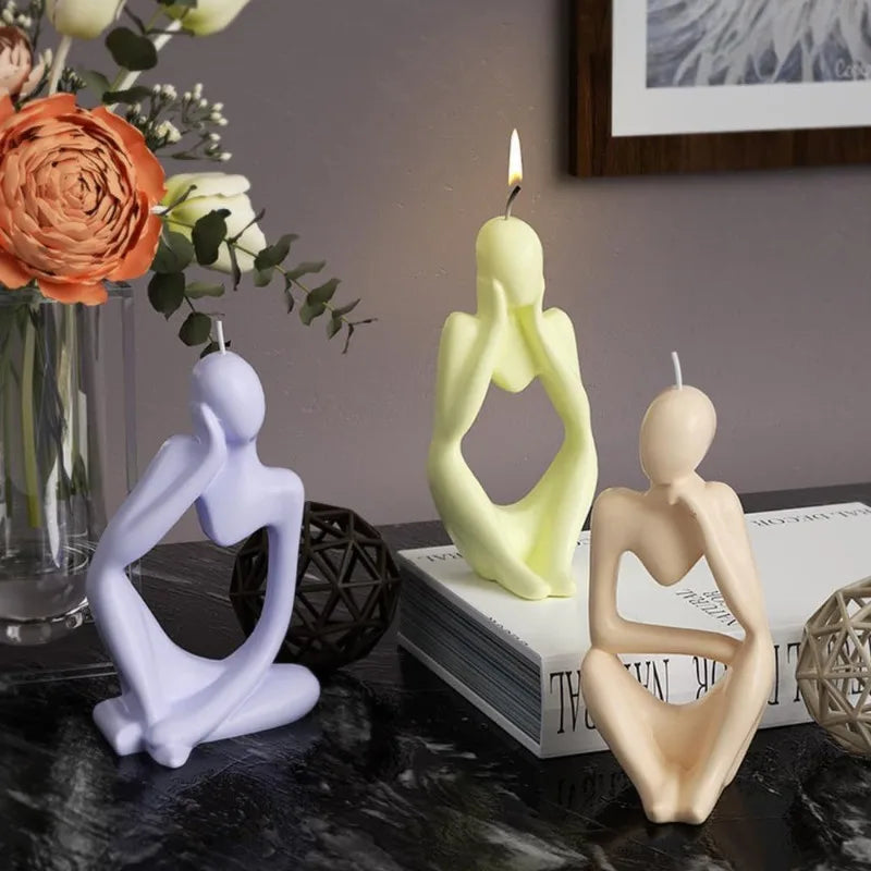 A set of abstract silicone molds shaped like figures and candles for resin art and crafting
