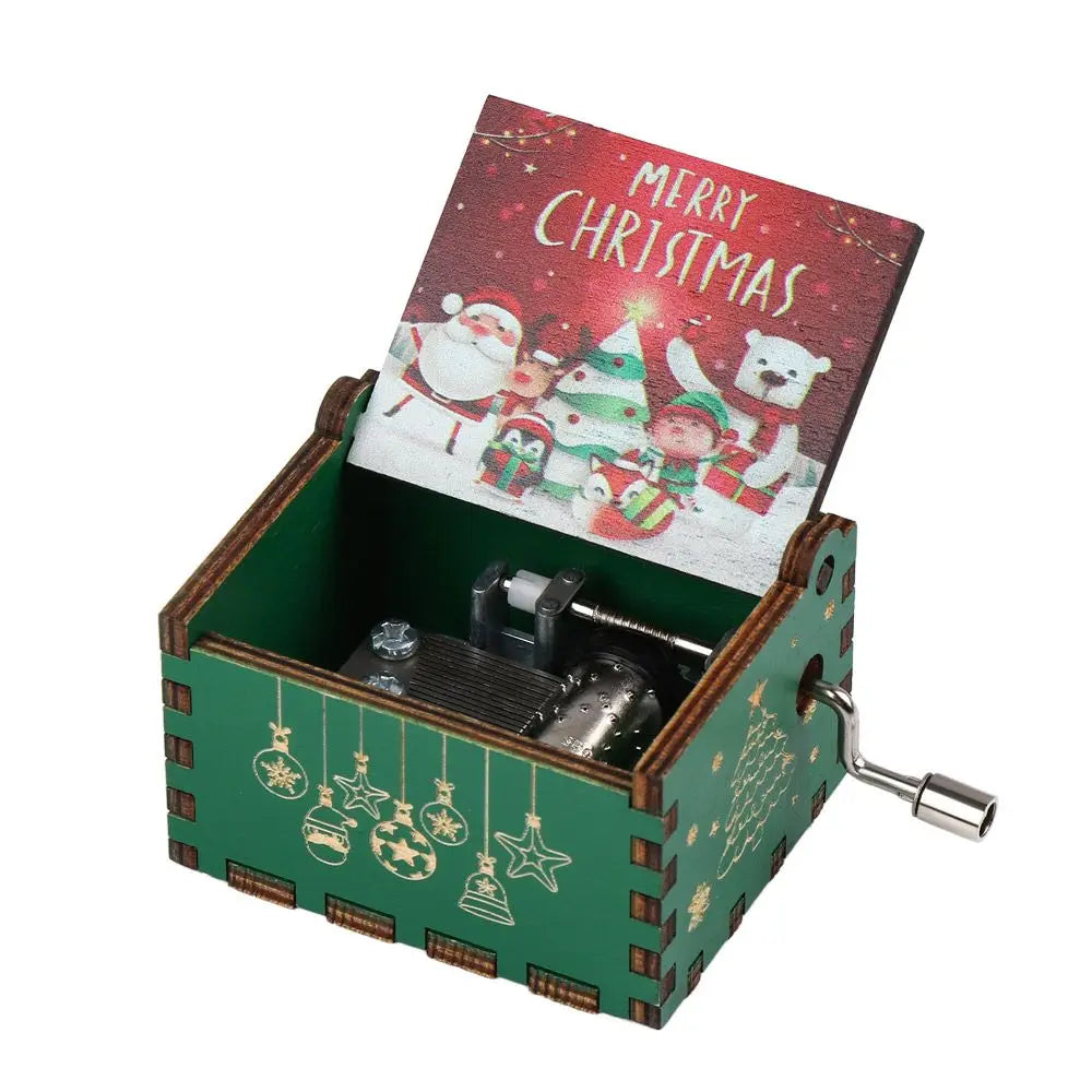 A vintage hand-cranked wooden music box with a red Christmas card visible inside.