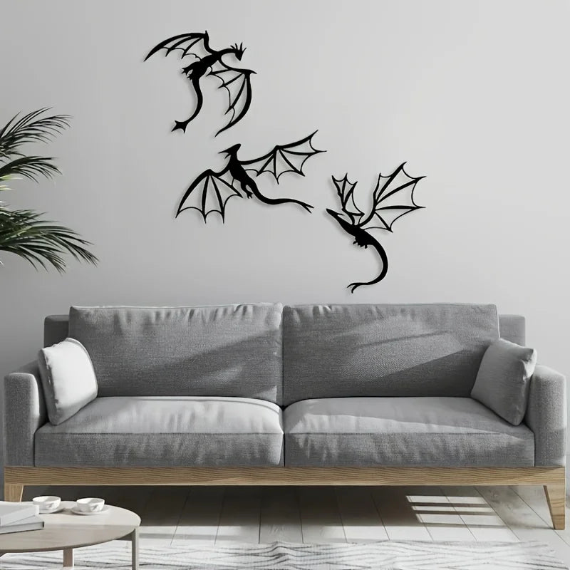 A gray sofa in a living room features three black dragon metal wall art panels above it.